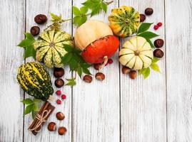 Pumpkins with autumn leaves photo