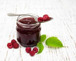 Raspberry jam with fresh berries photo