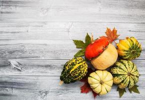 Pumpkins with autumn leaves photo