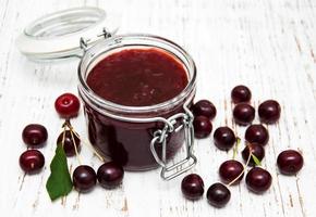 Cherry jam with fresh berries photo