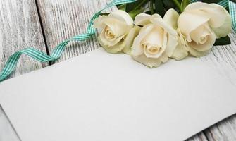 White roses with greeting card photo