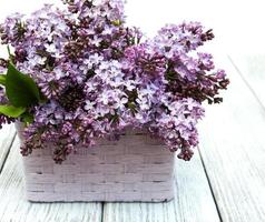 Lilac flowers on table photo