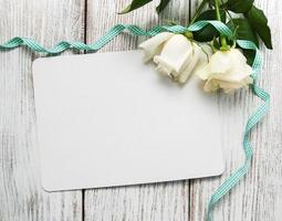 White roses with greeting card photo