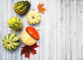 Pumpkins with autumn leaves photo