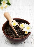 Dry green tea with jasmine flowers photo