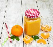 Jar with orange juice photo