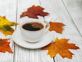 taza de café y hojas de otoño foto