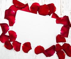 Red roses petals with card photo