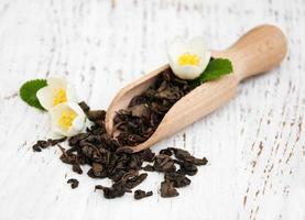 Dry green tea with jasmine flowers photo