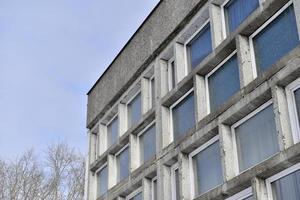 An old stone building with large windows photo