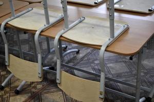 Chairs and desks in the school classroom photo