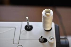 New White sewing machine with threads at home photo