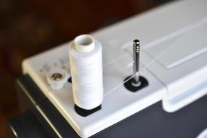 New White sewing machine with threads at home photo
