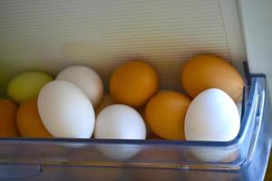 White and red eggs in the refrigerator photo