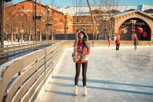 portrait of a beautiful girl at the rink in winter photo