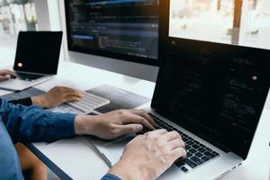 Two software developers are analyzing together about the code written into the program on the computer. photo