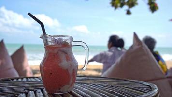 mango, pineapple, watermelon and yoghurt or yogurt smoothies jar with sea beach background video