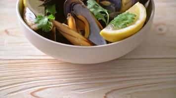 fresh mussels with herbs in a bowl with lemon video