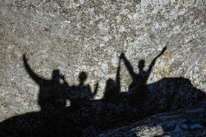 Shadow of a group of people on a rock photo