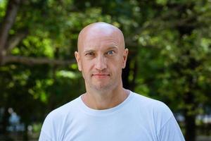 portrait of a bald man on a park background photo