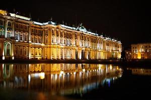 Reflection in a puddle illuminated building in St. Petersburg on Palace square photo