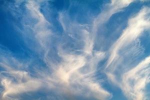 blue sky with white feather clouds photo