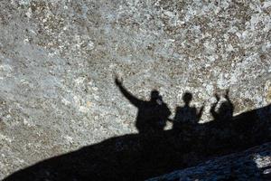 Shadow of a group of people on a rock photo