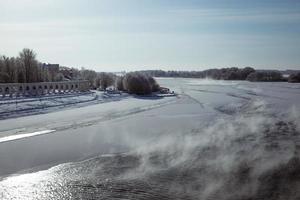 Winter view of the river with icy edges and snow-covered banks in winter. Nice photo