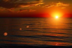 beautiful sky with clouds at sunset over the sea photo