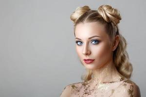 portrait of beautiful blonde woman with makeup beauty photoshoot on background photo