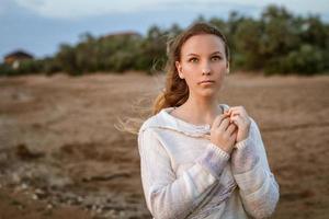 girl on the shore sad expression photo