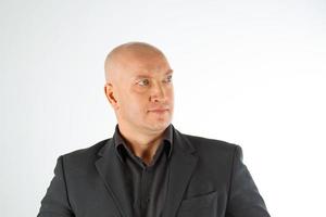 Portrait of a bald man in a black shirt and jacket on a white background, businessman photo