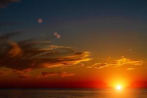 beautiful sky with clouds at sunset over the sea photo