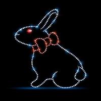 Easter bunny silhouette with red bow. Made from gemstones diamonds with rhinestones isolated on a black background. On a black background. Vector illustration.