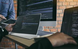 Asian man working code program developer computer web development working design software on desk in office. photo