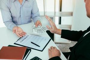 Businessperson refusing bribe given money by partner with anti bribery corruption concept. photo