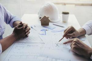 Team architect or engineering people discussion working on table together at a construction site. photo