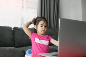 Asian kindergarteners are studying online with teachers at computers during school hours while the virus is pandemic. photo