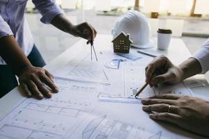 Team architect or engineering people discussion working on table together at a construction site. photo