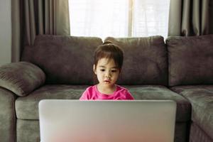 Asian kindergarteners are studying online with teachers at computers during school hours while the virus is pandemic. photo