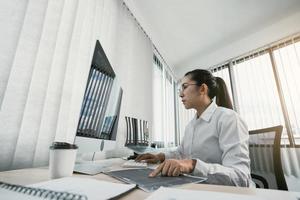 Woman asian software developers are analyzing together about the code written into the program on the computer in office room. photo