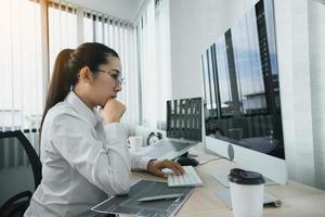 Asian female software developers are stressed in analyzing code-based systems. photo