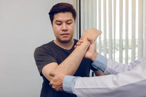 Asian physiotherapists check the elbows of patients who have undergone orthopedic rehabilitation. photo