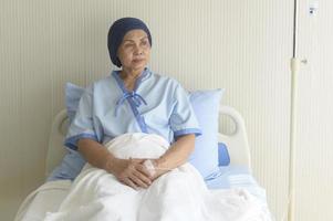 Portrait of senior cancer patient woman wearing head scarf in hospital, healthcare and medical concept photo