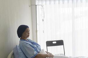 Portrait of senior cancer patient woman wearing head scarf in hospital, healthcare and medical concept photo