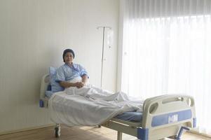 Portrait of senior cancer patient woman wearing head scarf in hospital, healthcare and medical concept photo