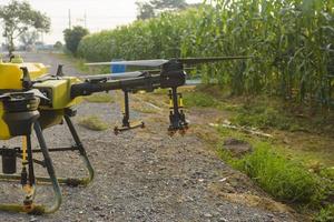 Agriculture drone flying and spraying fertilizer and pesticide over farmland,High technology innovations and smart farming photo