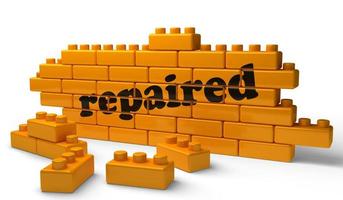 repaired word on yellow brick wall photo