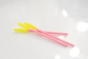 Brushes for eyebrows and eyelashes.  Disposable brushes for eyebrows and eyelashes. Colored brushes pink and yellow photo