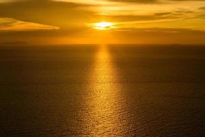 The sky before sunrise with reflection in the sea. photo